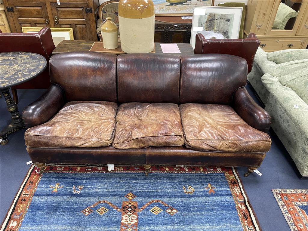 A George Smith Howard style brown leather three seater sofa, length 210cm, depth 106cm, height 84cm